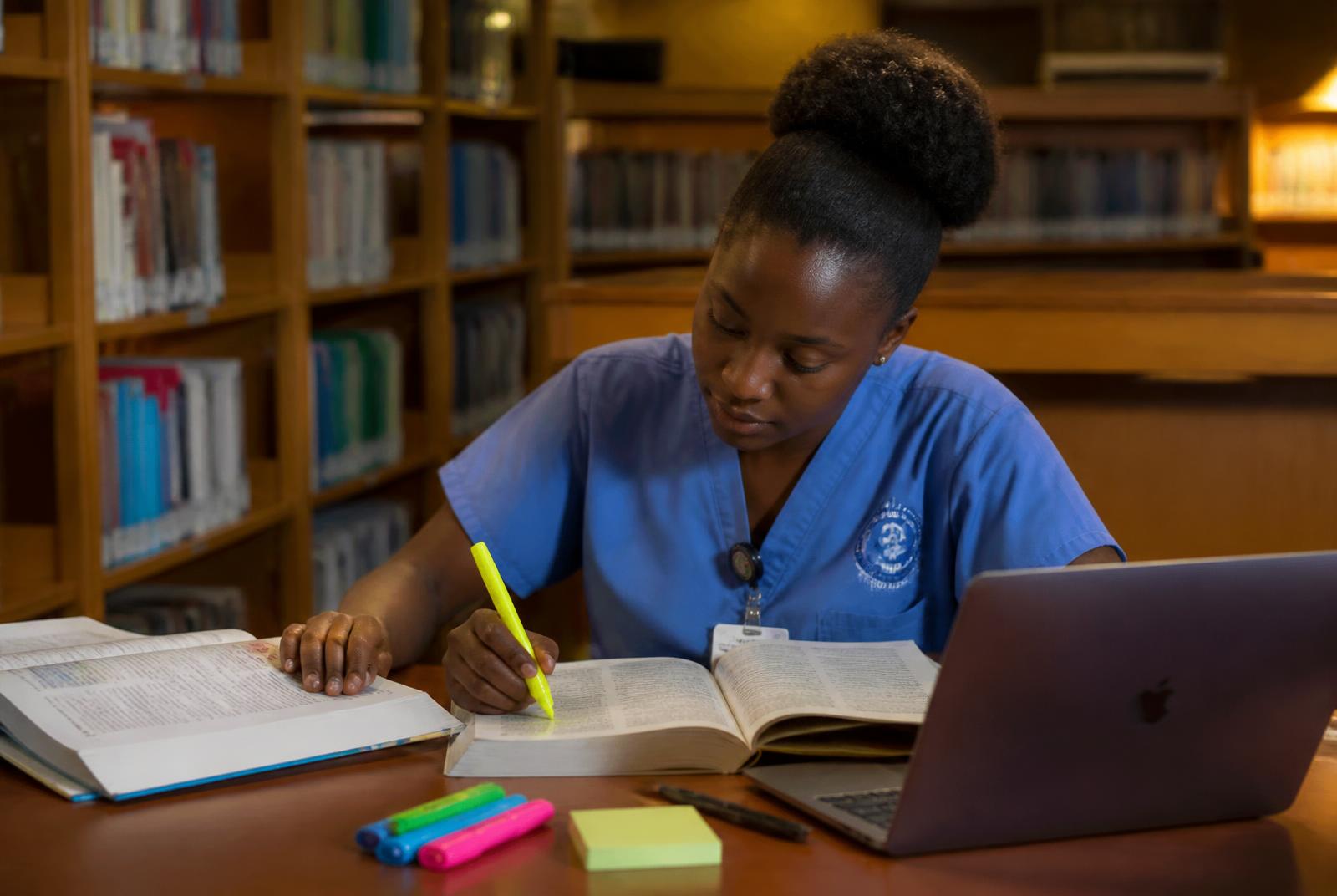 Nurse studying for a licensing exam in a library